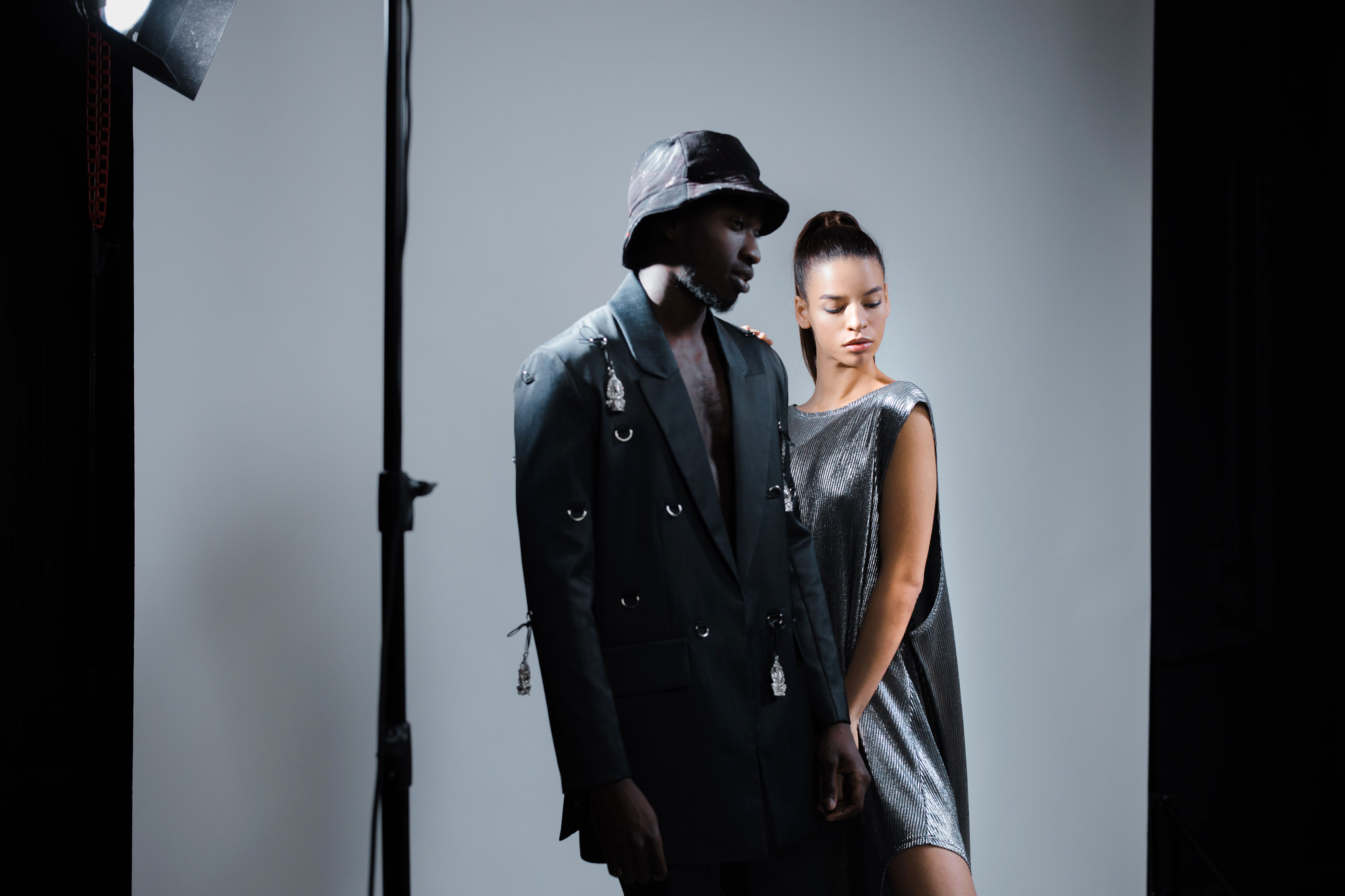 Models posing under studio lighting during a fashion shoot.
