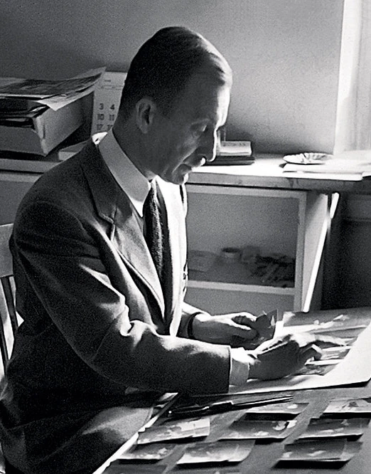 Alexey Brodovitch examines prints and editorial material at his worktable
